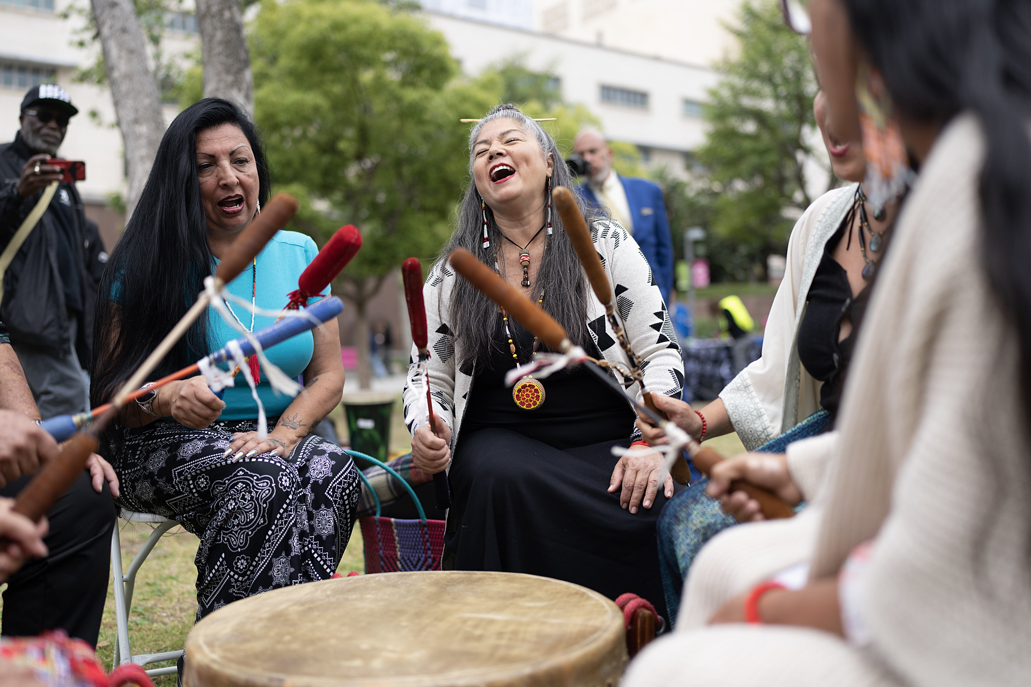 Community members engage in a drumming circle, celebrating cultural heritage and unity in Los Angeles County.