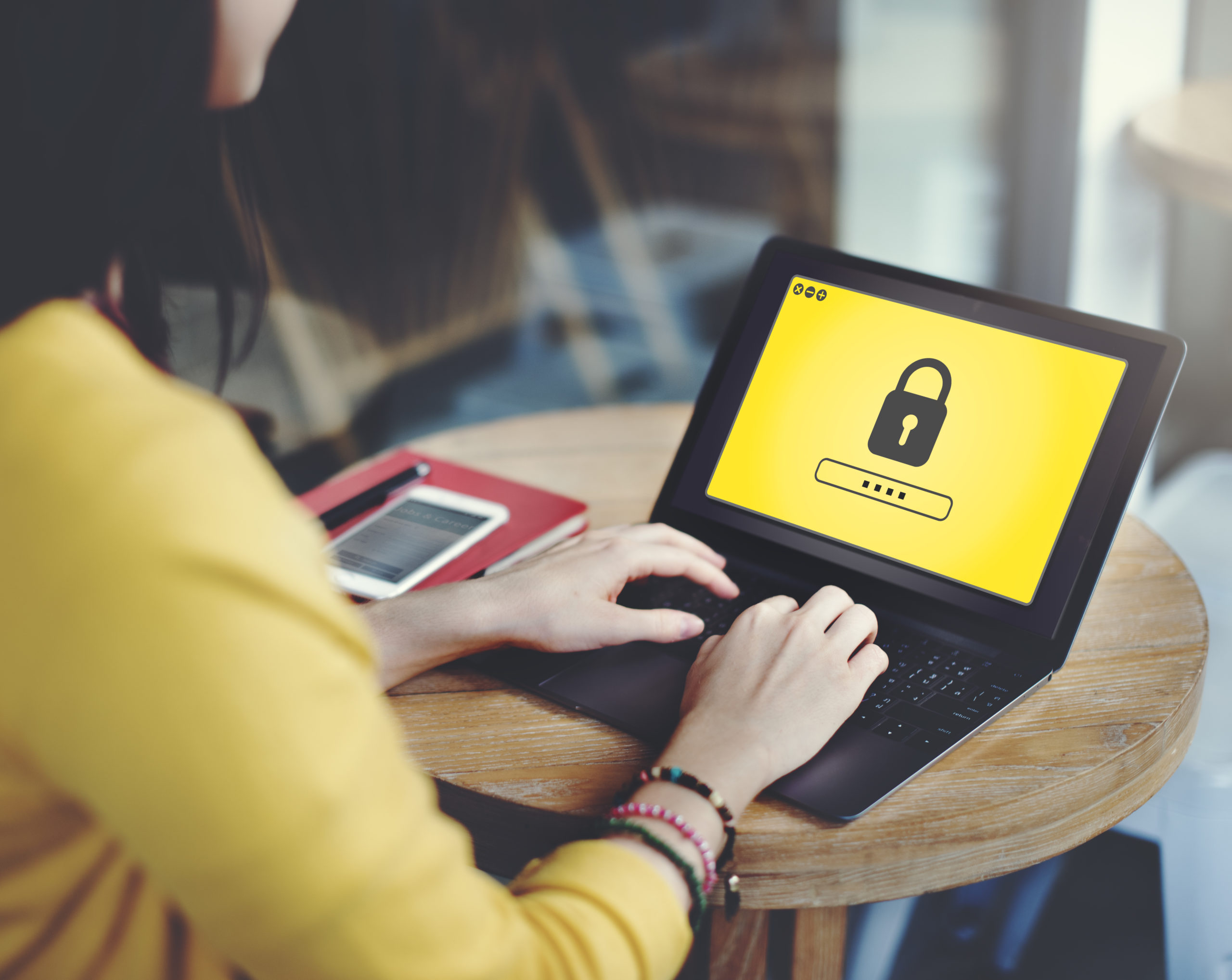 A person types on a laptop displaying a password entry screen, emphasizing digital security and community engagement.